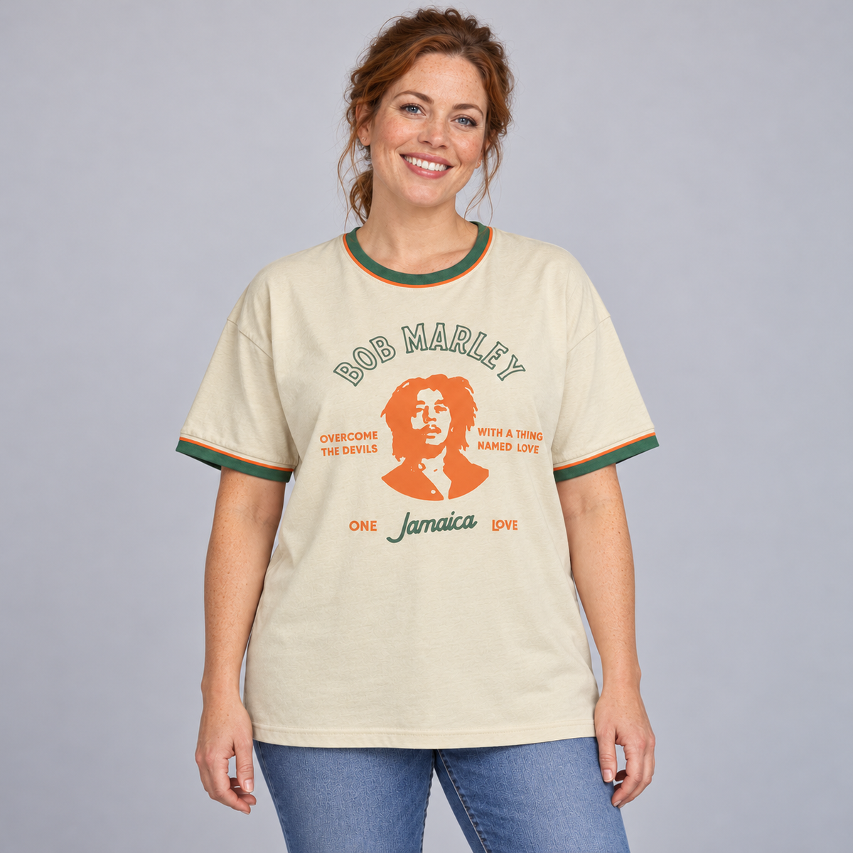 Woman wearing the cream Bob Marley ringer T-shirt with green and orange trim in a relaxed unisex fit.
