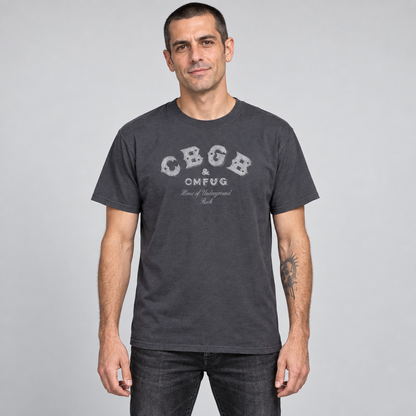 Man wearing the charcoal CBGB classic logo T-shirt in a full-length relaxed unisex fit, studio photograph.