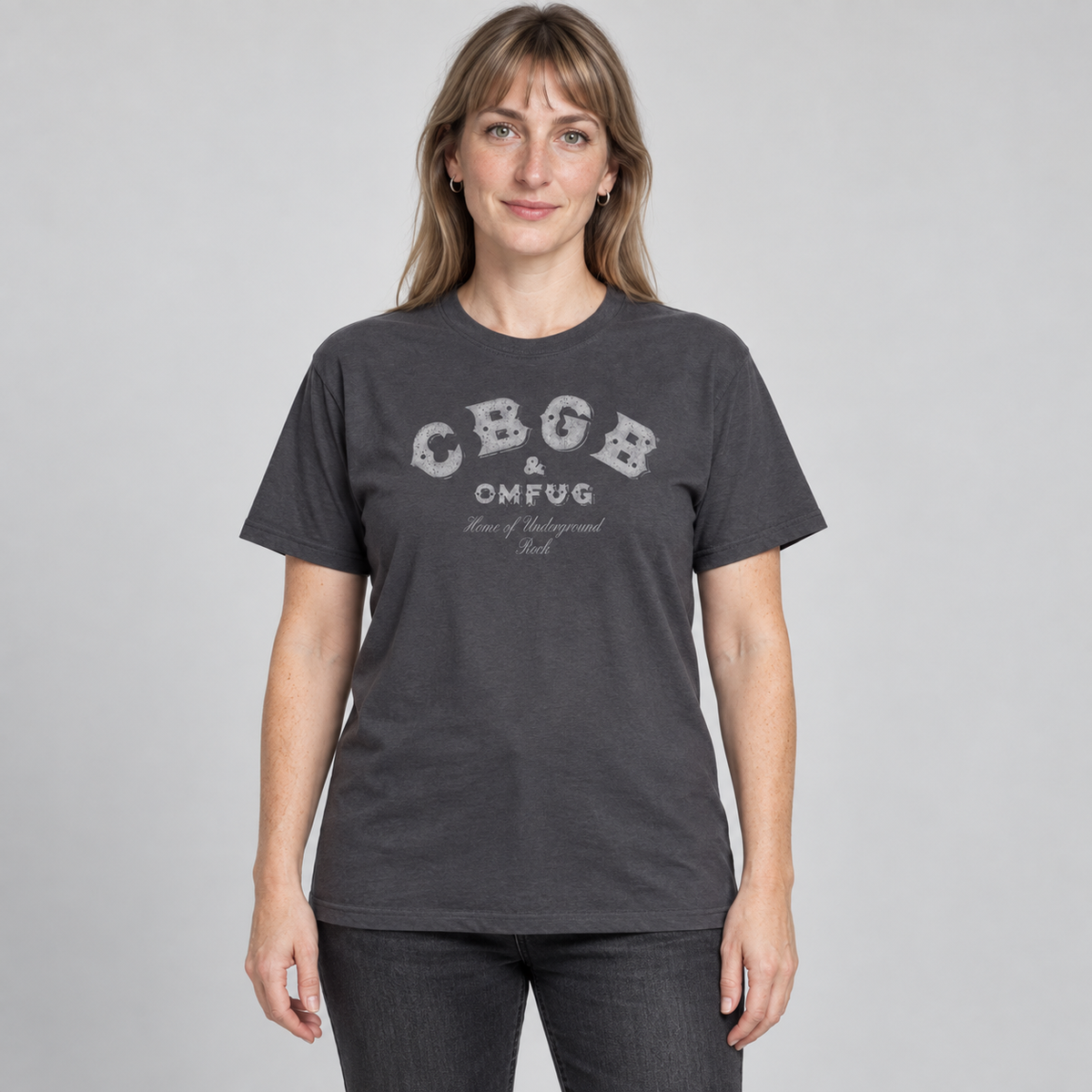 Woman wearing the charcoal CBGB classic logo T-shirt in a full-length relaxed unisex fit, studio photograph.