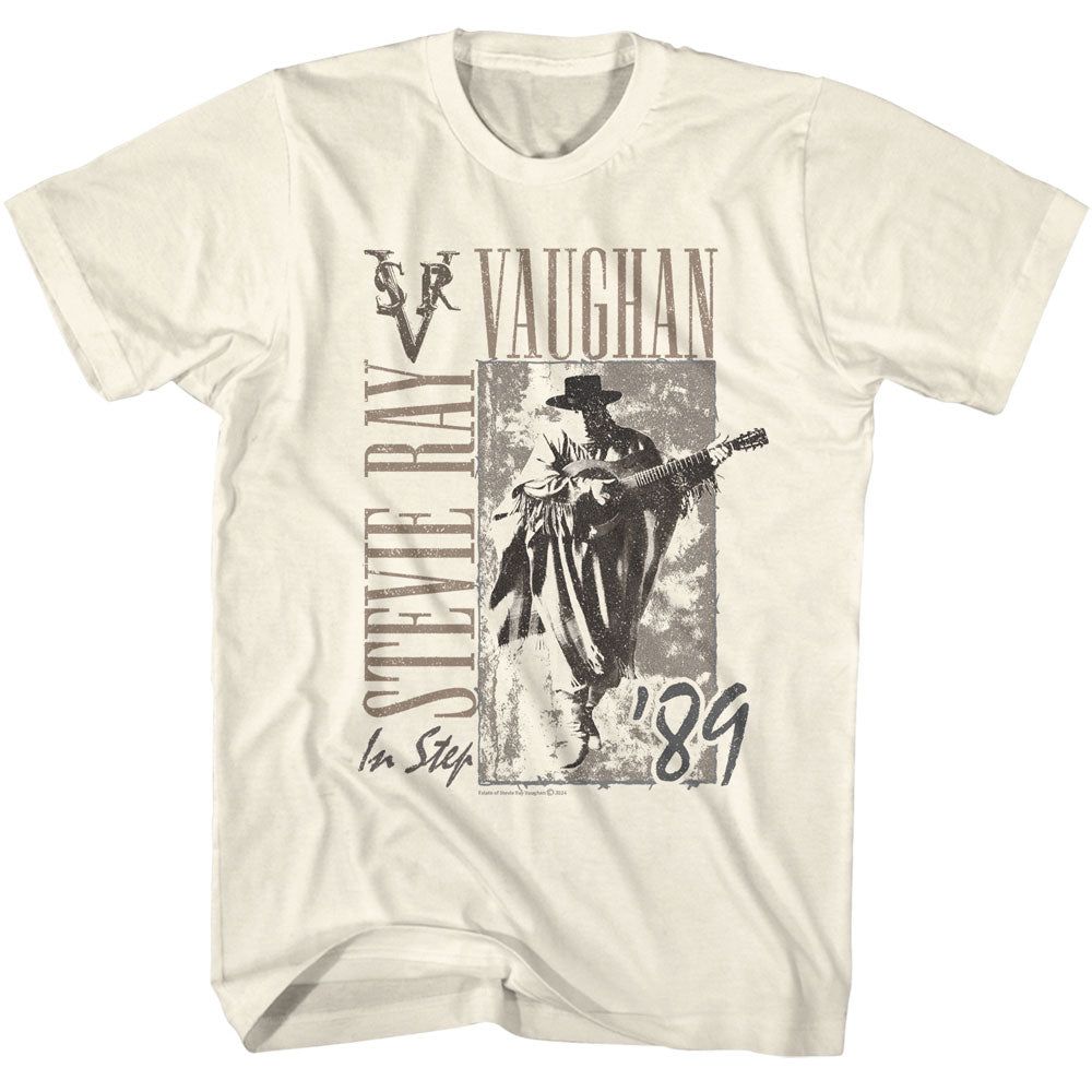 A beige t-shirt featuring a graphic print of Stevie Ray Vaughan with a guitar and the text &