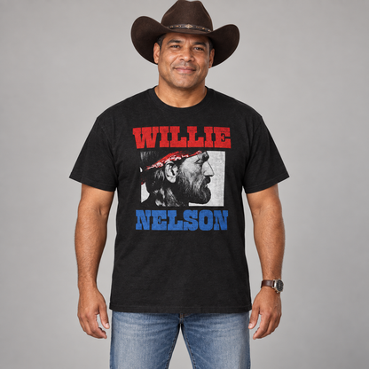 Male country music fan wearing the black Willie Nelson Stare unisex T-shirt in a studio.