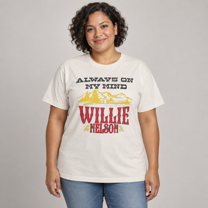 Woman wearing the natural Willie Nelson Always On My Mind T-shirt with a full-length relaxed unisex fit in a studio.