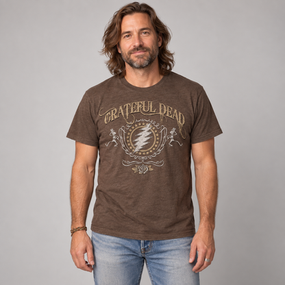 Studio photo of a man wearing the brown Grateful Dead Bolt T-shirt, showing vintage lightning bolt, skeleton and rose artwork.
