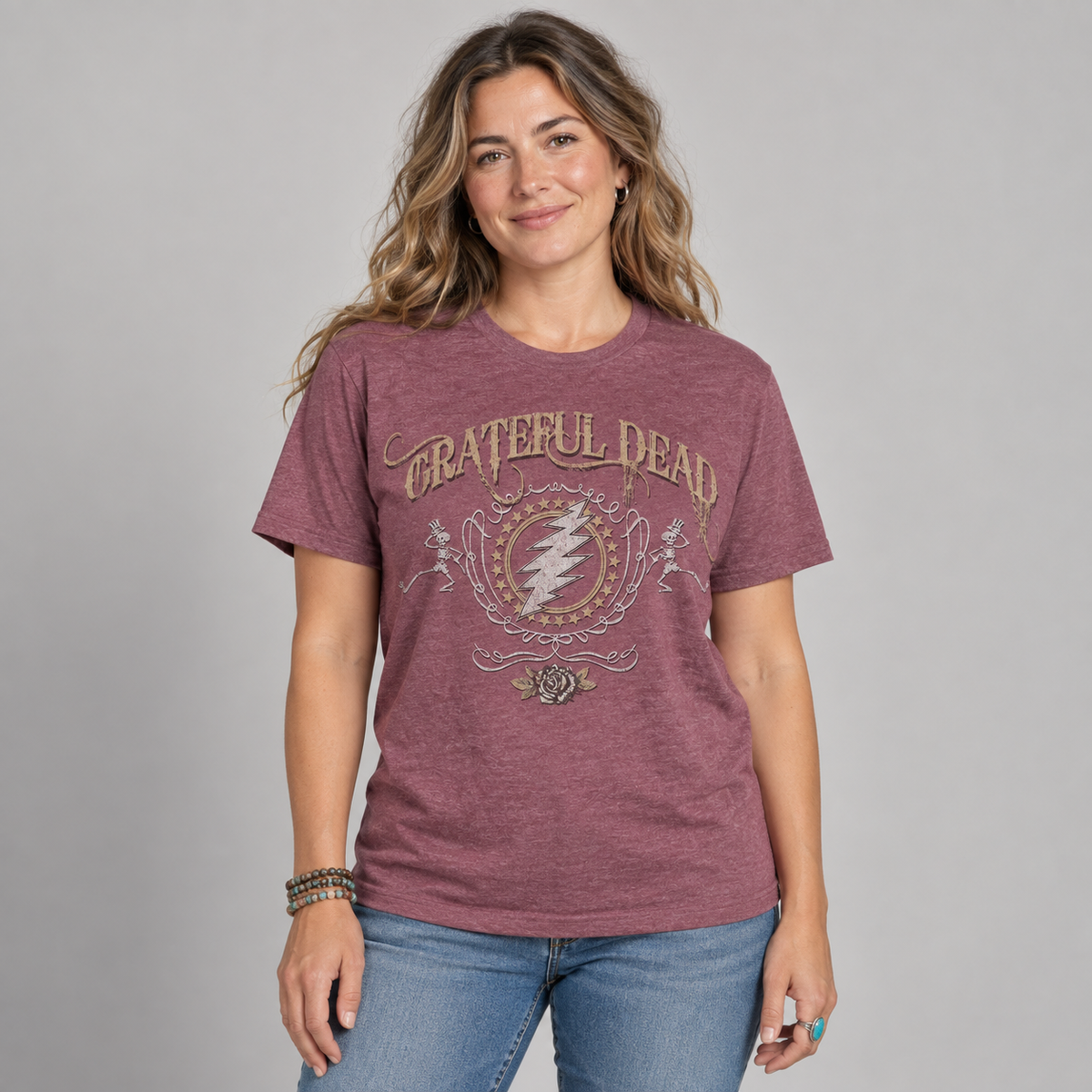 Studio photo of a woman wearing the heather cardinal Grateful Dead Bolt T-shirt with vintage lightning bolt, skeleton and rose artwork.