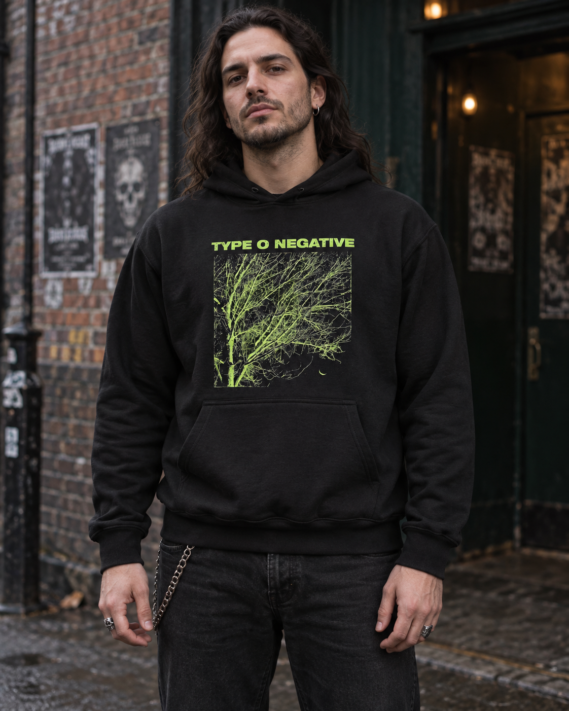 Man wearing the black Type O Negative Tree pullover hoodie outside a rock club, showing the green front artwork.